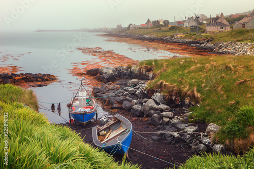 Small fishing boats on a foggy morning in Berneray, North Uist, Outer Hebrides, Scotland