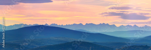 Принти на полотні Wide angle panorama autumn forest,misty hills mountain tops in pink dawn