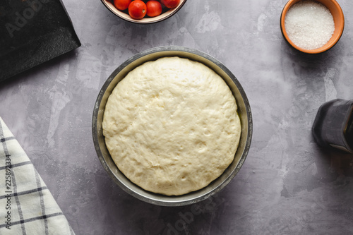Ingredients for Italian bread Focaccia, raw dough, olive oil, tomatoes, sea salt.