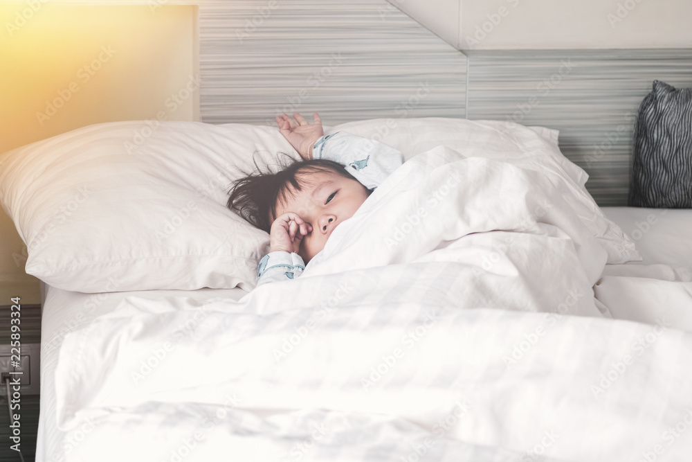 Asian Little girl wakes up from sleep.Good morning at home Asian Little girl wakes up from sleep.Good morning at home