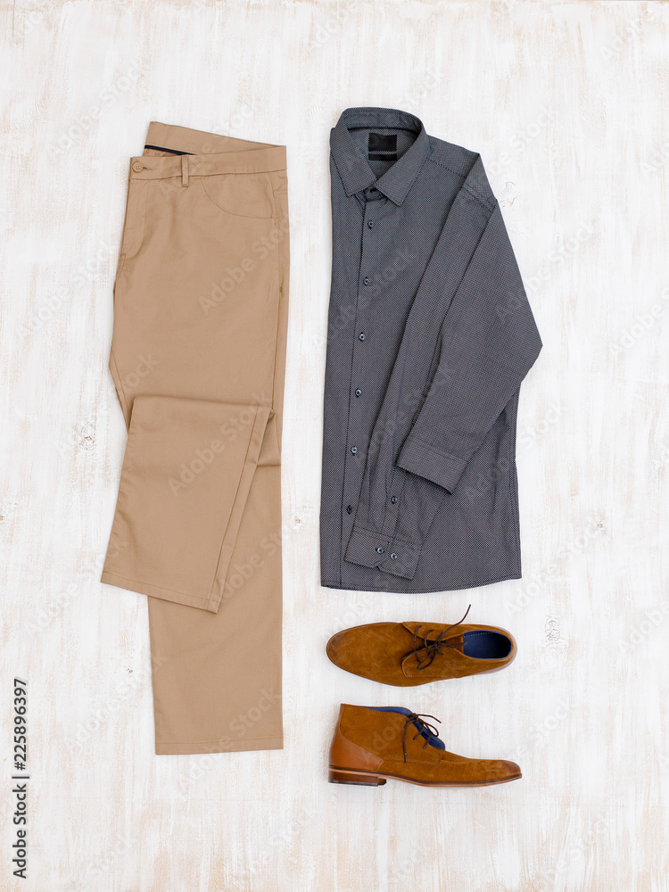Beige pants, grey shirt and brown suede shoes. Overhead view of men's  casual outfit on white wooden background. Flat lay, top view. Photos |  Adobe Stock