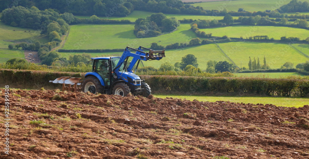 Naklejka premium Tractor ploughing field in Axe Valley in Devon