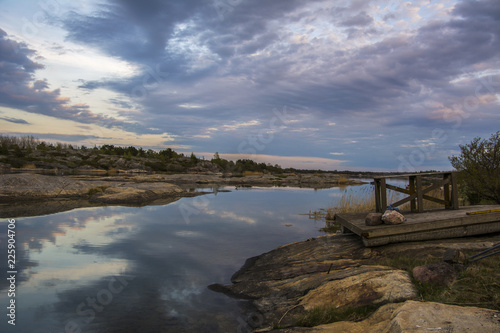 Beautiful evening view, sea water, rocky landscape, clouds and reflection, Kumlinge, Aland islands, Finland photo