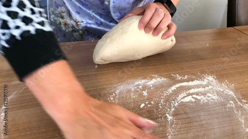 The woman kneads the dough