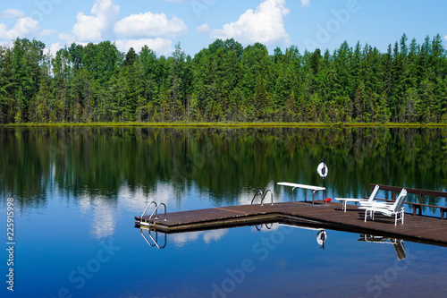 Lake Lac Perron Dock and lounge chairs reflection