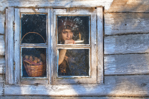 witch is looking out the window, waiting for someone impatiently. she even tries to light a candle space near his hut, that's how curious...
