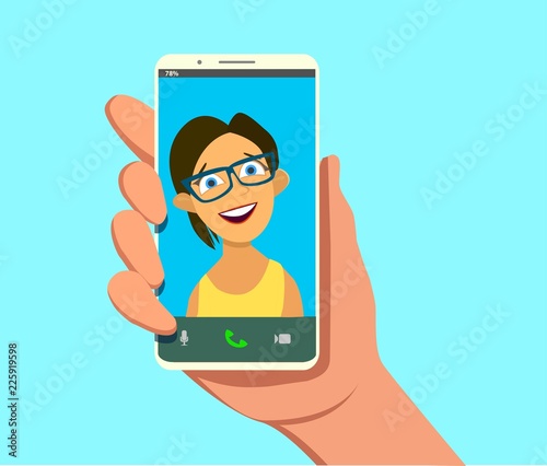 Young beautiful Smiling girl on display smartphone. Human hand holding mobile phone and looking at the screen. Chat, Video call, self portrait.