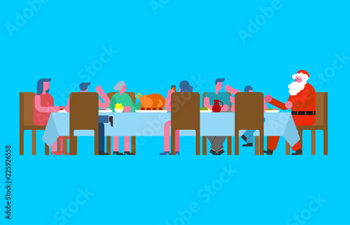 Family Christmas dinner and Santa. Big table. Red caps. holiday lunch new year. Father and mother. Grandmother and grandfather. Relatives feast