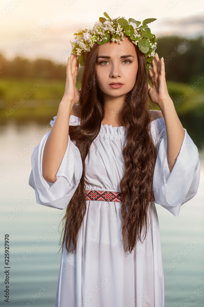 Woman in white dress in the water. Art Woman with wreath on her head in ...
