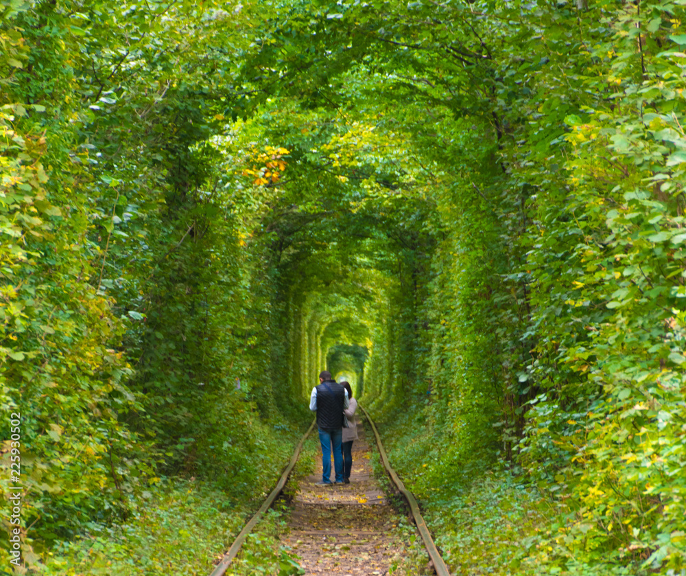 Couple are walking in nature tunnel