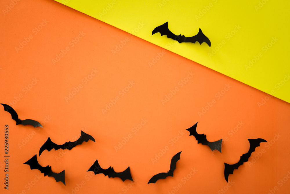 Flying bats on orange background