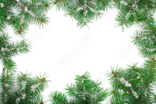 Christmas Frame of Fir tree branch with snow isolated on white background with copy space for your text. Top view