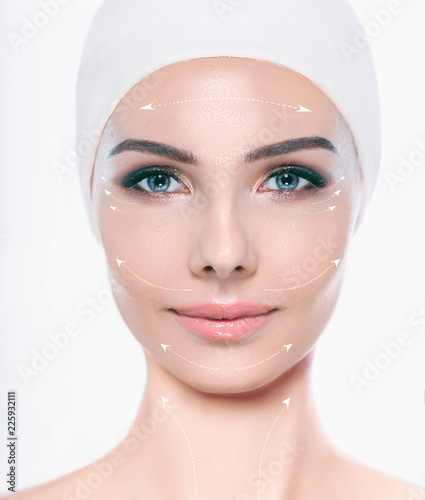 Face of beautiful woman with perfect skin , with lifting arrows on face, concept of facial surgery and face lifting. Cosmetology, elastic and young skin of the face.