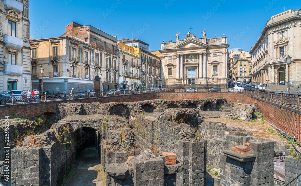 The roman amphitheater with San Biagio Church in Catania in a summer morning. Sicily, southern Italy.
