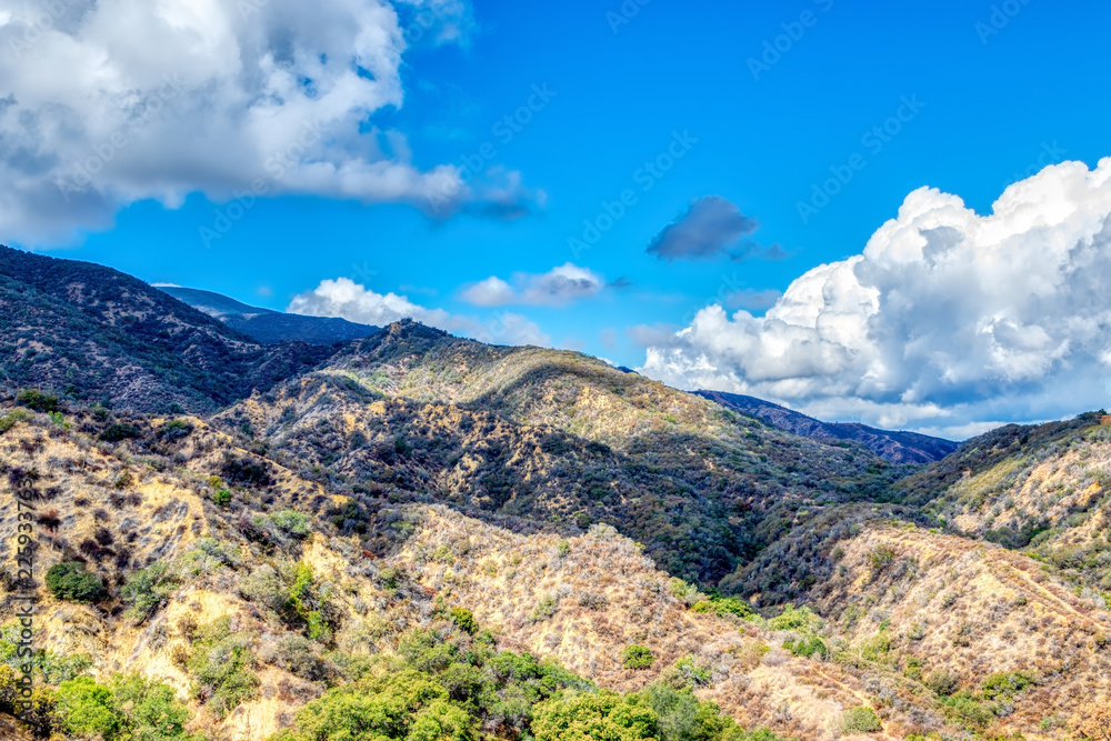 Naklejka premium Shadows from morning rain clouds over foothills of California mountains