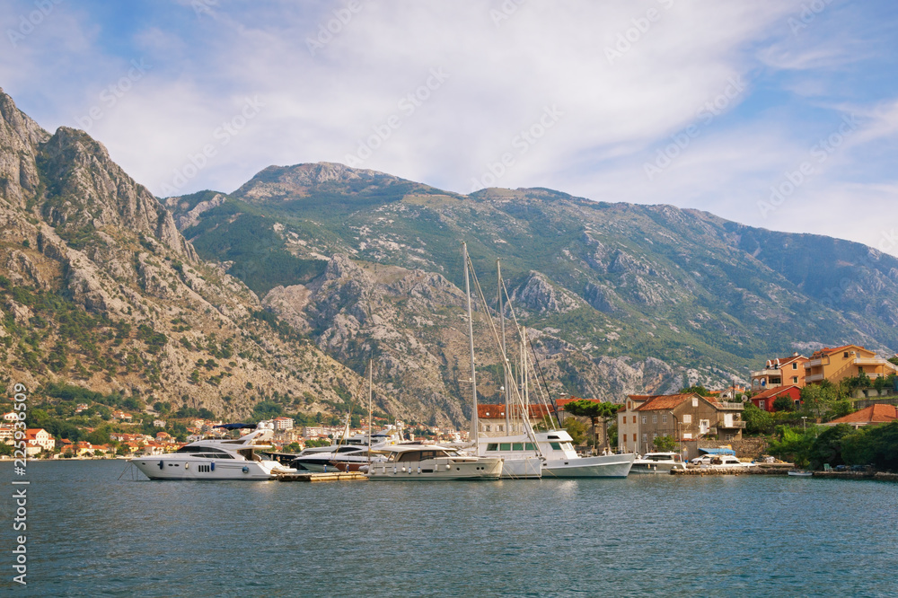Mediterranean landscape with yachts moored at the pier. Montenegro, Adriatic Sea, Bay of Kotor, Muo village