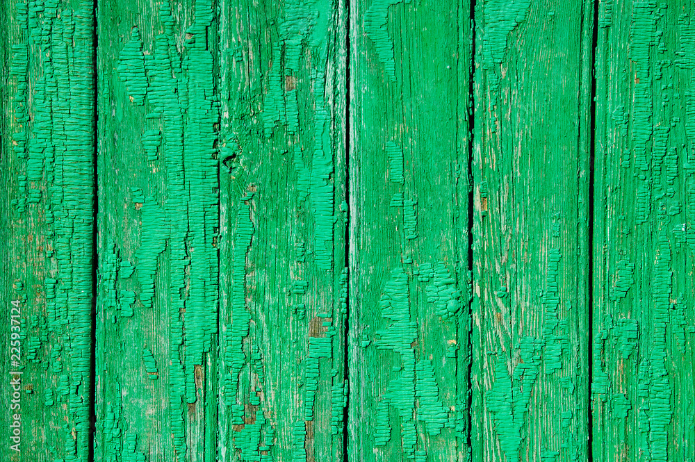 The texture of the shabby wooden green planks. Close-up. The texture of the shabby wooden green planks. Close-up.