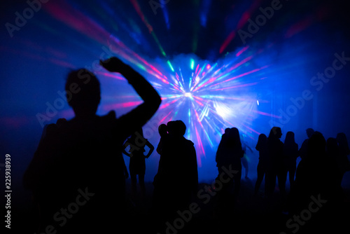 Abstract blurry background, silhouettes of people at open air party