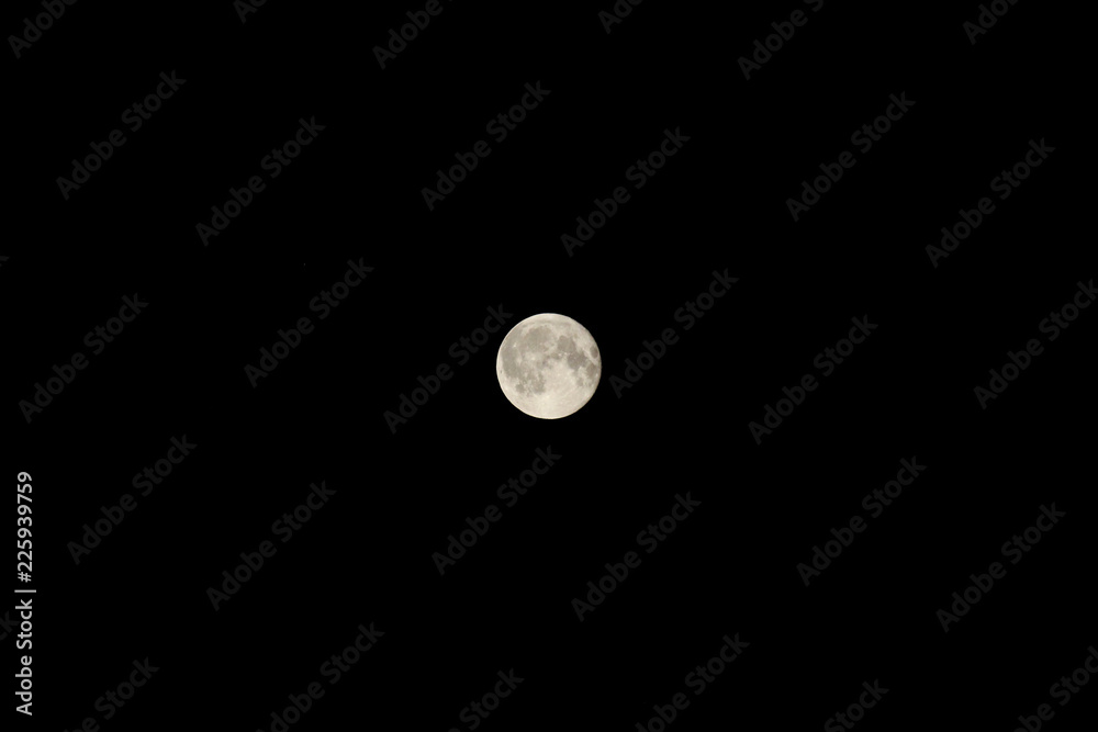 Bright full moon against the black night sky