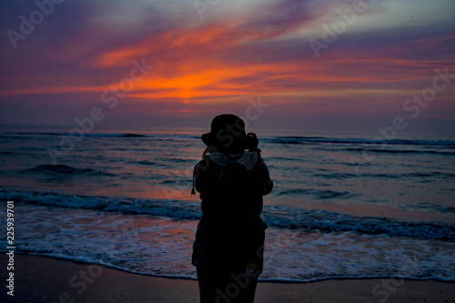 Girl shooting sunset, North Sea