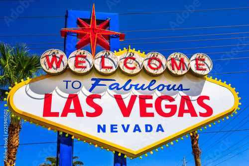 Welcome to Fabulous Las Vegas Nevada, popular landmark Las Vegas Sign on Las Vegas Strip at entrance of the city. Nevada, Unites States. Blue sky.