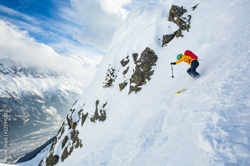 Winer day in Chamonix. Rider is skiing down the hill.