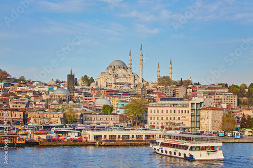 Istanbul cityscape with boats and Suleymaniye Mosque