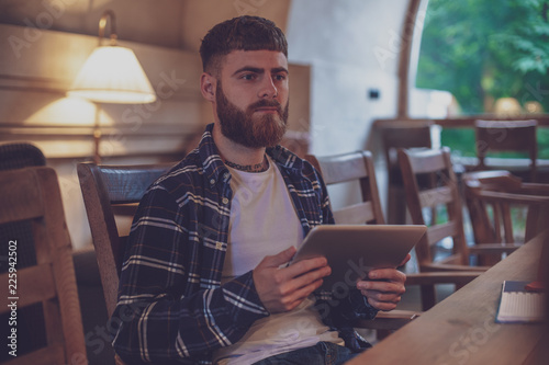 Freelancer dressed in casual outfit focus on reading news and lo photo