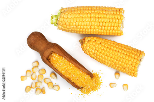 corn groats or cornmeal in wooden scoop and corncob isolated on white background. Top view. Flat lay photo