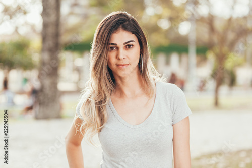 Portrait of beautiful young woman outdoors on sunny day