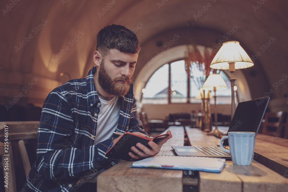 Casual business man or freelancer planning his work on notebook, Casual business man or freelancer planning his work on notebook,