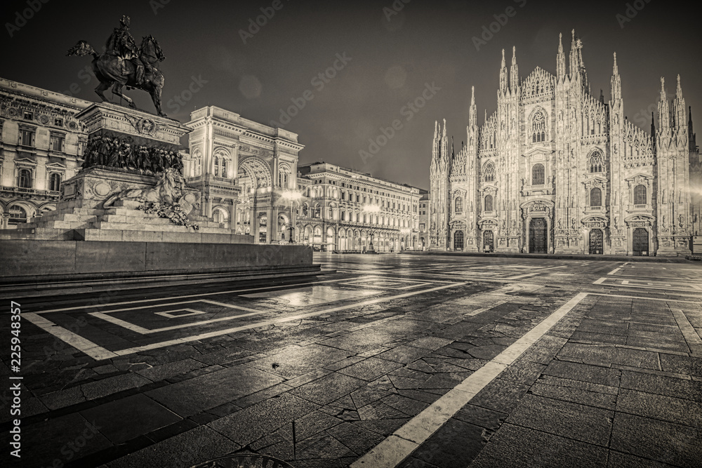 Black and white vintage look image of Piazza del Duomo in Milan Italy. Autumn night.
