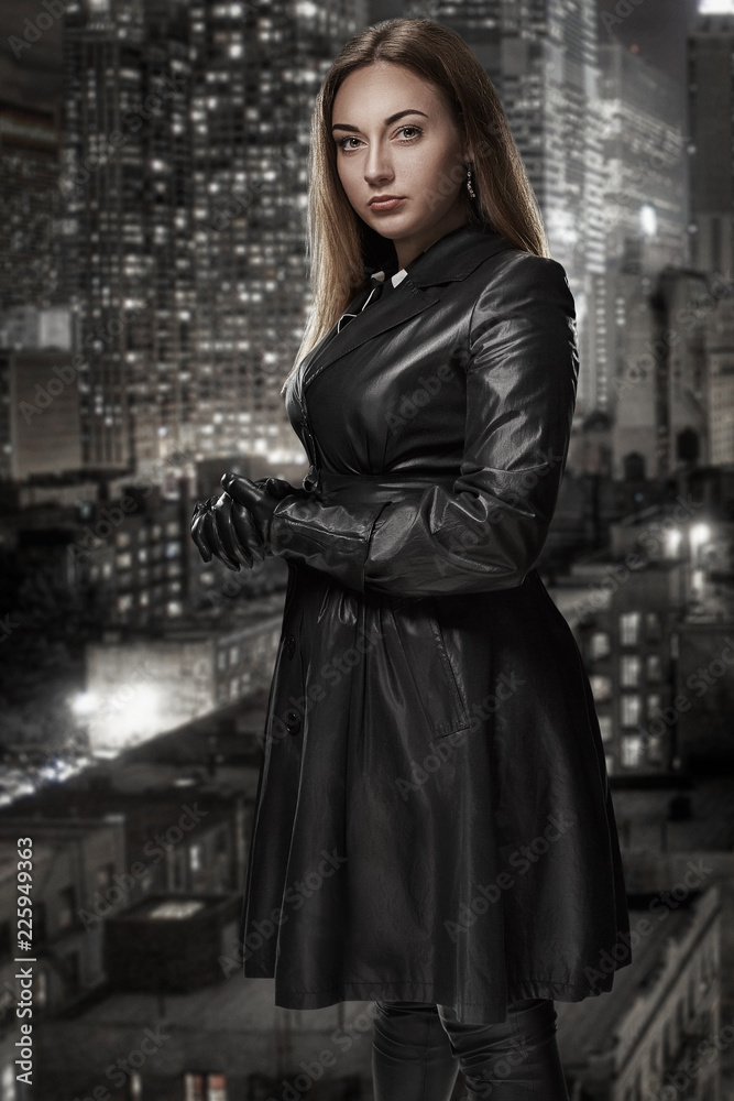 Retro portrait of inaccessible beautiful woman in black cloak stands against the background of the night city. Film noir. Vintage Hollywood style. Studio shot. Retro portrait of inaccessible beautiful woman in black cloak stands against the background of the night city. Film noir. Vintage Hollywood style. Studio shot.