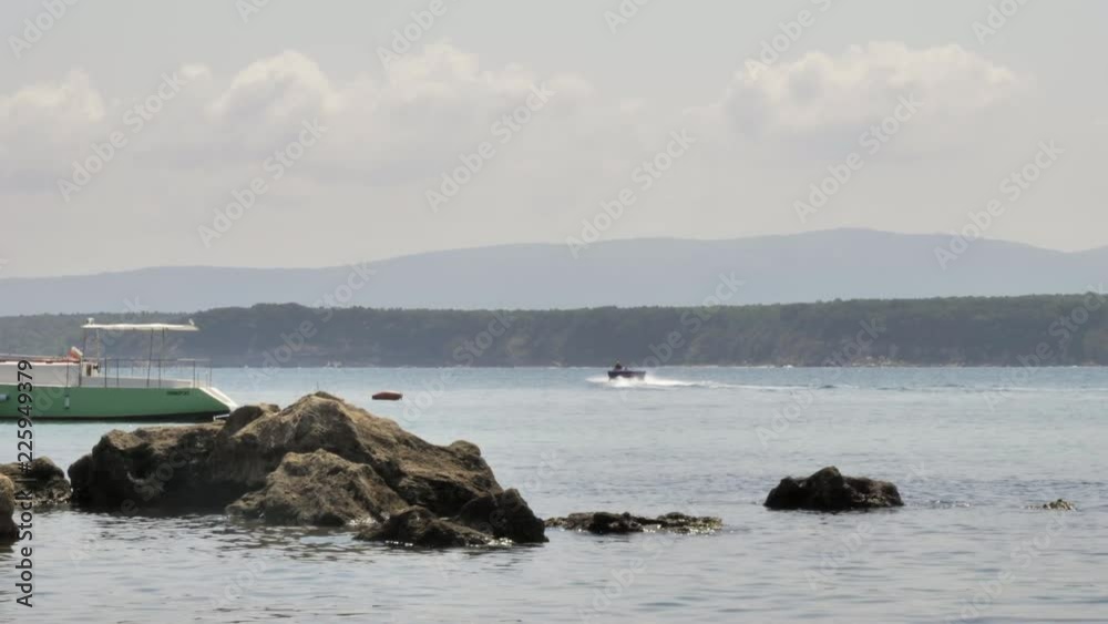 Man riding personal water craft on the sea Man riding personal water craft on the sea