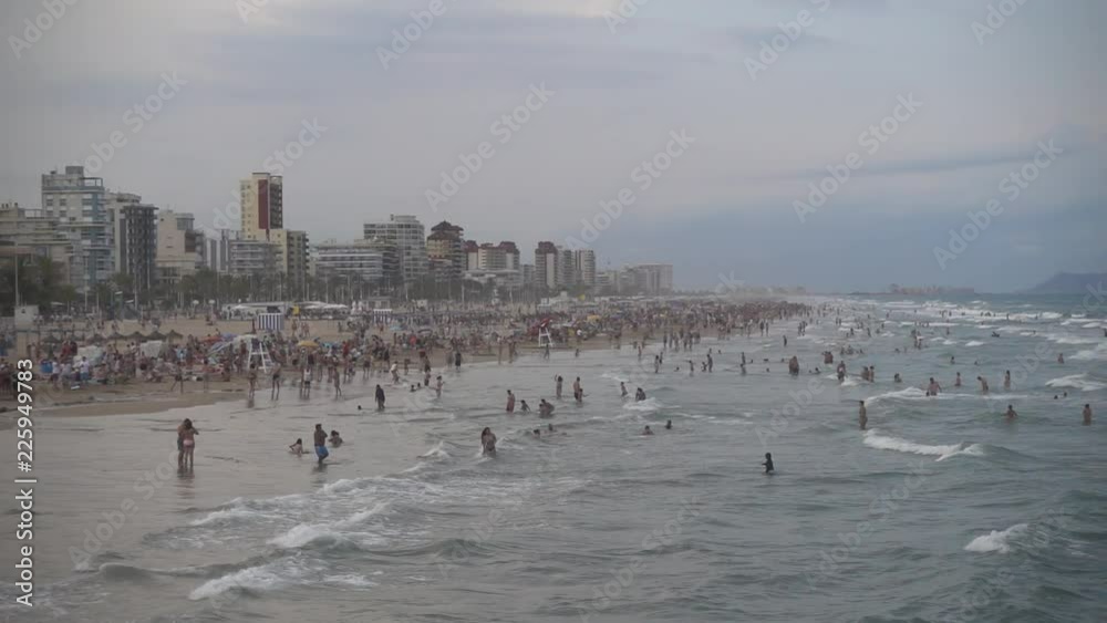 People enjoy a beautiful summer day in the beach of Gandia, Spain People enjoy a beautiful summer day in the beach of Gandia, Spain