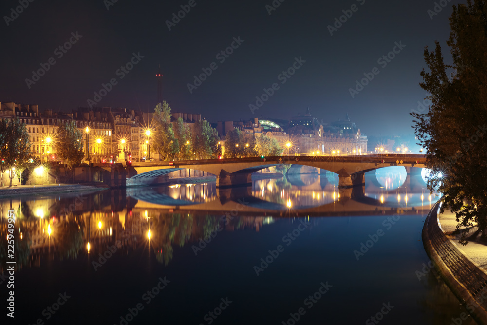 Seine, Pont du Carrousel and Orsay Museum at night in Paris, France
