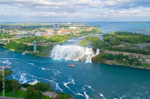 Niagara Falls. American falls.  Boat with tourists moves along Bride Veil Falls. Canada, USA. photo
