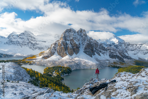 A lone figure watches the clouds cover Mount Assiniboine 
