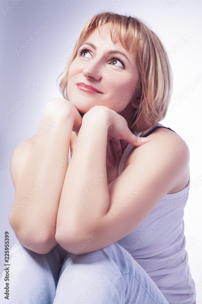 Portrait of Dreaming Caucasian Blond Woman in Casual Clothing. Posing Against White.