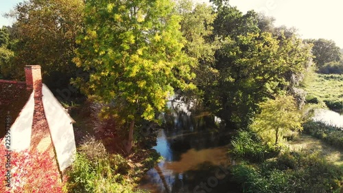 Backwards reveal aerial shot of Willy Lott's house scene of the painting 'the haywain' by john constable at flat ford, suffolk, england