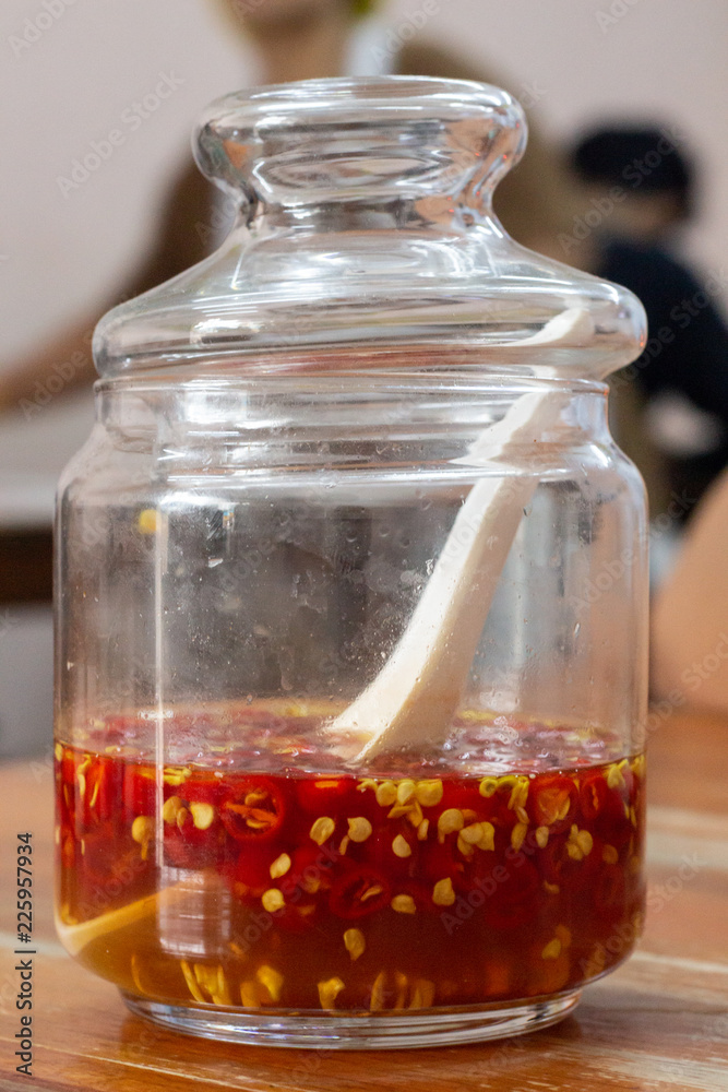Fish sauce with chili in glass bottle isolated on white background Fish sauce with chili in glass bottle isolated on white background