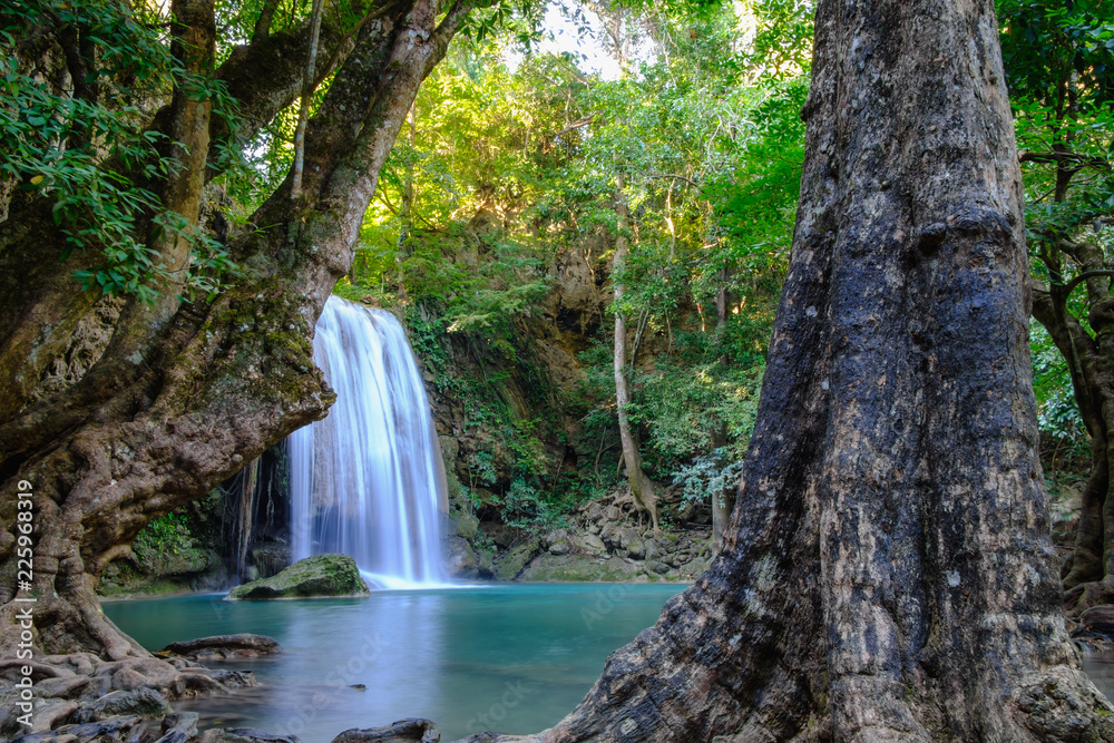 Jungle landscape with flowing blue water of Erawan waterfall with beautiful in the Kanchanaburi Province, Thailand.