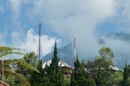 A tower of cellular communication on a hill of a mountain in clouds