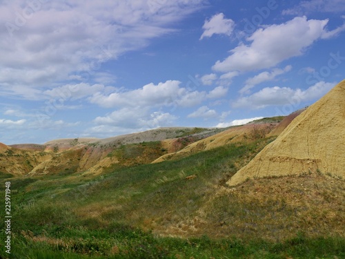 Medium wide shot of scenic rock formations and landscape at Badlands National Park in South Dakota, USA.