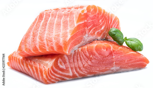 Fresh raw salmon fillets decorated with green basil.