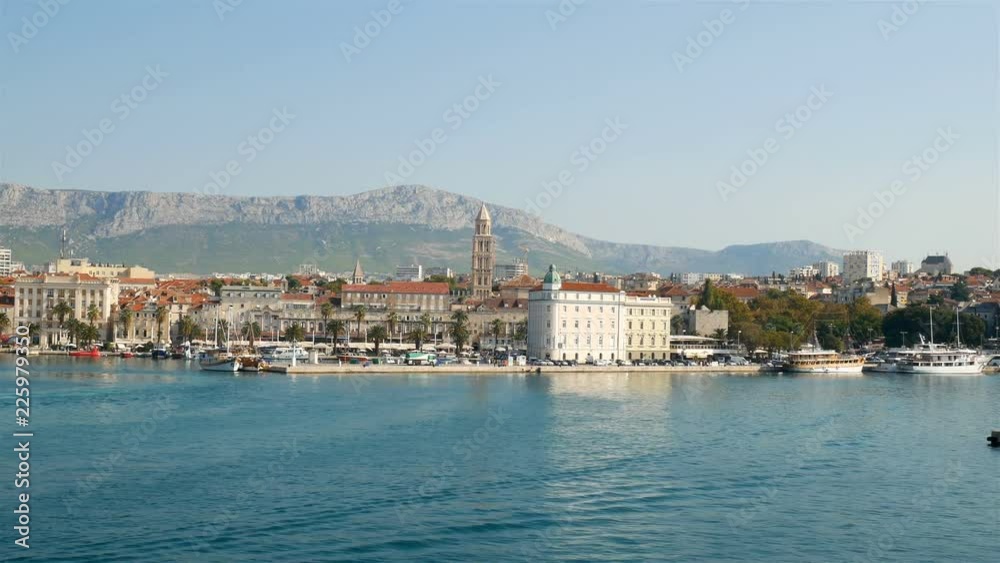 Coming with boat on harbor in city of Split in Croatia with cathedral of Saint Domnius at background Coming with boat on harbor in city of Split in Croatia with cathedral of Saint Domnius at background
