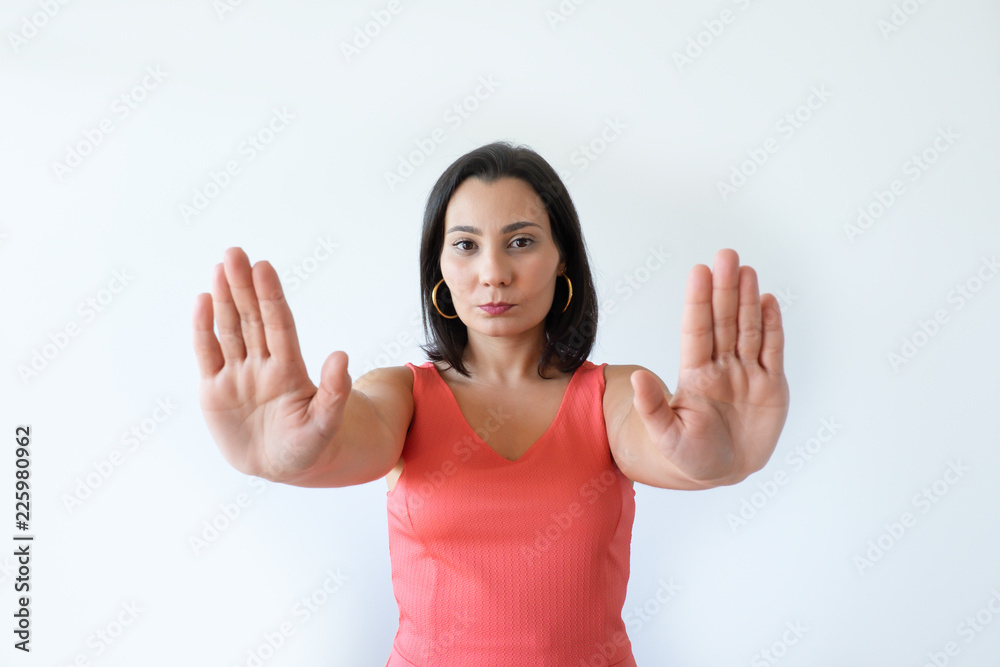 Confident attractive Caucasian woman showing stop symbol with both hands. Pretty middle aged female model gesturing. Refusal concept. Confident attractive Caucasian woman showing stop symbol with both hands. Pretty middle aged female model gesturing. Refusal concept.