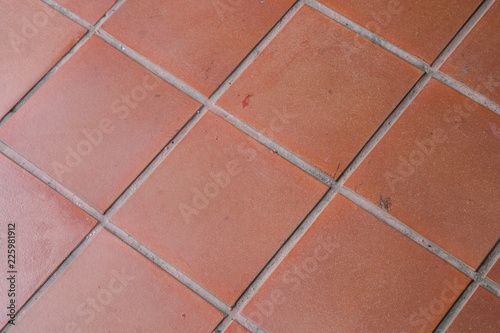 Orange tiles floor background, orange tile architecture wallpaper and background. Red brick paving stones on a floor © kanpisut