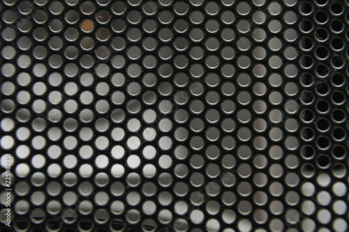 the texture of a shallow metal mesh that covers the speakers