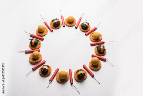 Rangoli or design made using Indian snacks/sweet and firecrackers or patakhe for Diwali festival 